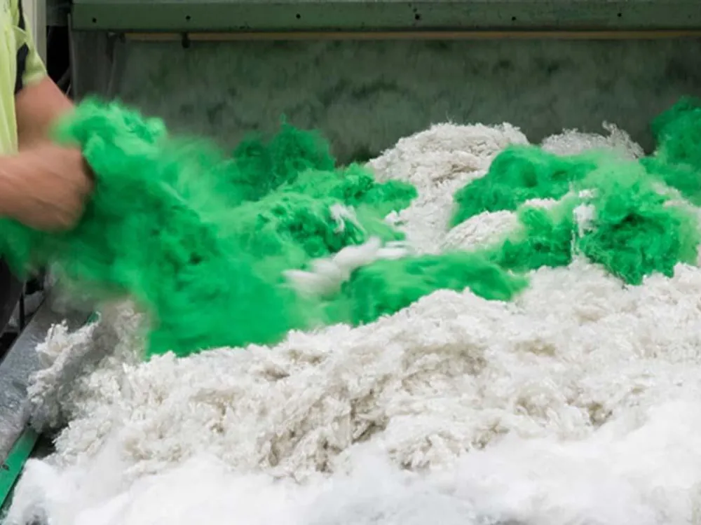 Coloured polyester offcuts being reprocessed back into white GreenStuf fibre on the Autex recycling line.