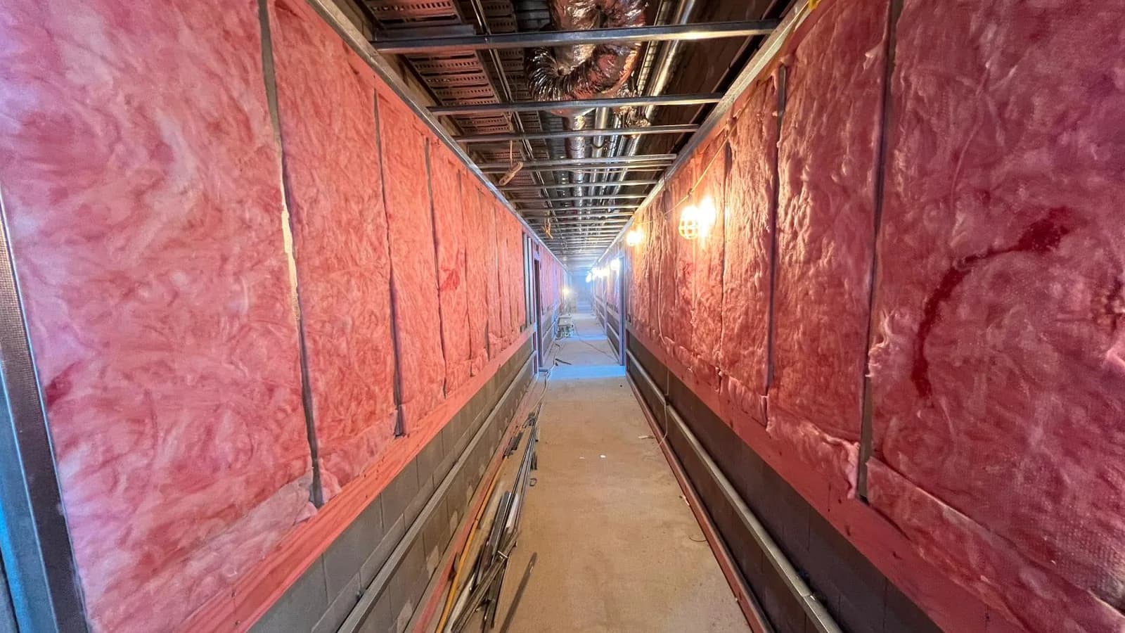 Glasswool insulation installed to the corridor walls on an R-Value Insulation Co commercial project.